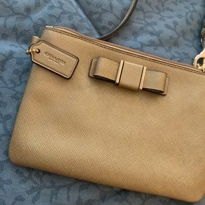 Small Coach gold textured wristlet